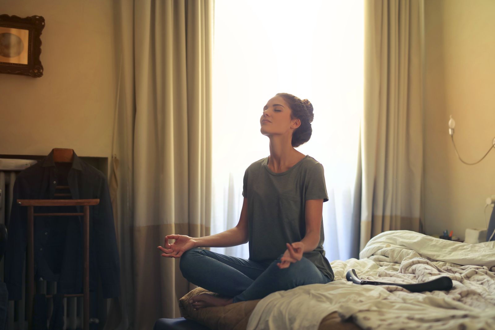 A woman practising gentle restorative yoga for hormonal balance