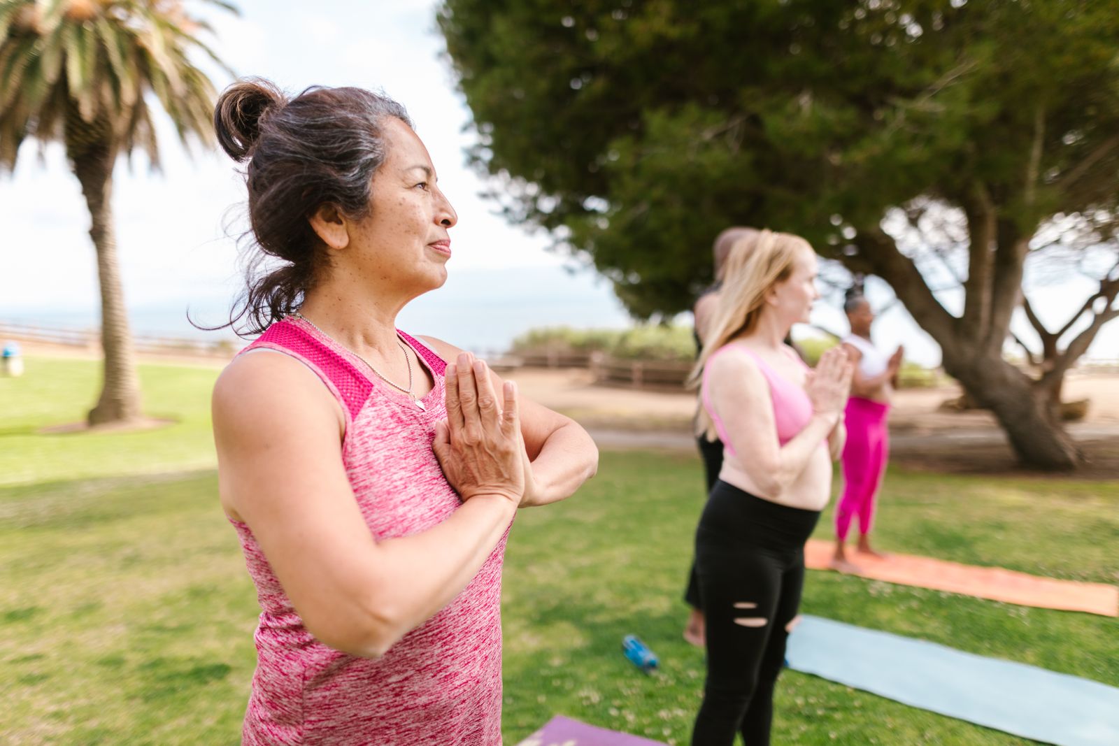 Beginners in a yoga training course in Rishikesh practising outdoors